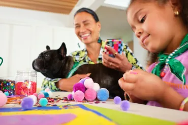 little girl and grandma with dog crafting